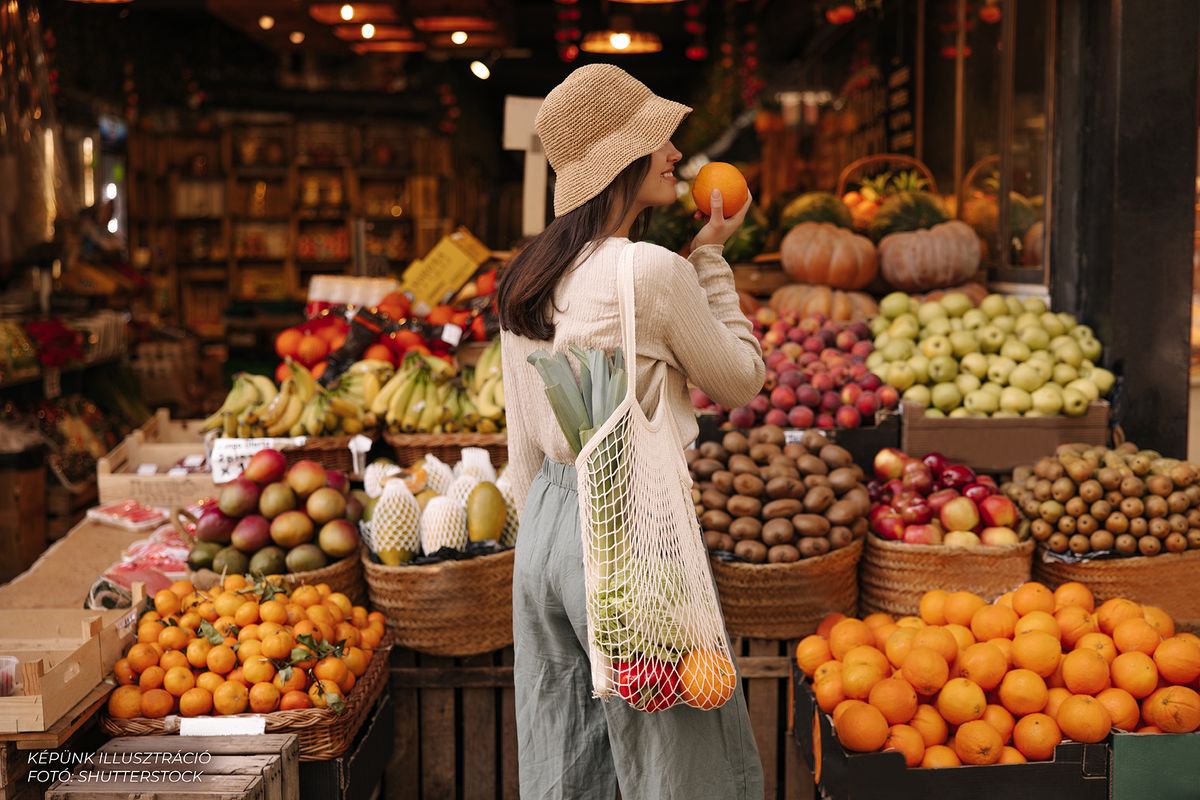 Fair-skinned,Young,Girl,Holds,Orange,Standing,With,Her,Back,To